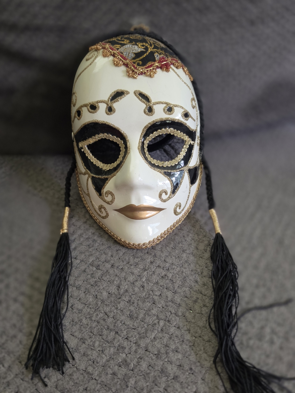 Decorative White and Black Venetian-Style Mask with Gold Accents
